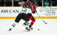 Boston defender Kaleigh Fratkin (13) pushes Ottawa forward Tereza Vanisova off the puck during second period PWHL hockey action in Ottawa on Wednesday, April 24, 2024. THE CANADIAN PRESS/Sean Kilpatrick
