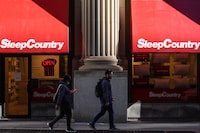 Pedestrians walk past a Sleep Country Canada store on Yonge Street in Toronto on Tuesday, October 19, 2021. Sleep Country Canada Holdings Inc. will give one of its newest acquisitions its first ever brick-and-mortar store next month. THE CANADIAN PRESS/Evan Buhler