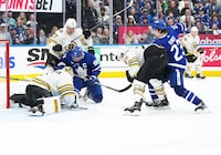 Apr 27, 2024; Toronto, Ontario, CAN; Toronto Maple Leafs center John Tavares (91) battles for the puck with Boston Bruins defenseman Hampus Lindholm (27) in front of goaltender Jeremy Swayman (1) during the third period in game four of the first round of the 2024 Stanley Cup Playoffs at Scotiabank Arena. Mandatory Credit: Nick Turchiaro-USA TODAY