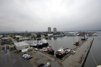 Tug boats sit docked in the port of Hamilton with the city in the rear, in Hamilton, September 30, 2013.  (J.P. Moczulski for The Globe and Mail)