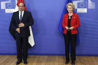 FILE - European Commission President Ursula von der Leyen, right, and Egypt's President Abdel Fattah El-Sisi pose for the media prior to a meeting on the sidelines of an EU Africa summit in Brussels, Thursday, Feb. 17, 2022. The European Union on Sunday, March 17, 2024, announced a $8 billion aid package for cash-strapped Egypt as concerns mount that economic pressure and conflicts in neighboring countries could drive more migrants to European shores. The deal is scheduled to be signed during a visit Sunday by European Commission President Ursula von der Leyen and leaders of Belgium, Italy, Austria, Cyprus and Greece, according to Egyptian officials.(Francois Walschaerts, Pool Photo via AP, File)