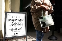 FILE PHOTO: A woman leaves a pop-up store of Chinese fast-fashion retailer Shein in Paris, France, May 5, 2023. REUTERS/Johanna Geron/File Photo