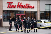 Toronto Police work the scene where a police officer was stabbed and a suspect shot in Toronto on Friday, April 12, 2024.  THE CANADIAN PRESS/Arlyn McAdorey