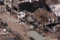 FILE - The wreckage of the Sari night club and surrounding buildings are seen in this aerial view Oct. 15, 2002 in Kuta, Bali. Relatives of some of the more than 200 people killed in 2002 bombings on the resort island of Bali are testifying at a sentencing hearing at Guantanamo Bay in Cuba. Two Malaysian men, both longtime detainees at Guantanamo, have pleaded guilty in connection with the bombing. (AP Photo/Achmad Ibrahim, File)