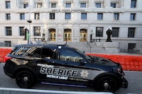 FILE PHOTO: A sheriff's vehicle passes by the Lewis R. Slaton Courthouse and Superior Court of Fulton County, after a Grand Jury brought back indictments against former U.S. President Donald Trump and 18 of his allies in their attempt to overturn the state's 2020 election results, in Atlanta, Georgia, U.S. August 17, 2023.  REUTERS/Brendan McDermid/File Photo