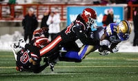 Winnipeg Blue Bombers running back Greg McCrae, right, is tackled by Calgary Stampeders linebacker Silas Stewart during second half CFL football action in Calgary, Alta., Friday, Oct. 27, 2023. THE CANADIAN PRESS/Jeff McIntosh