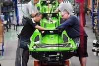 Employees work on the SeaDoo assembly line at the BRP plant on June 12, 2014 in Valcourt, Que.