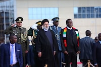 Iranian President Ebrahim Raisi is welcomed by Zimbabwean President Emmerson Mnangagwa, at Harare airport in Harare, Zimbabwe, on July 13, 2023. Iran's Presidency/Mohammad Javad Ostad/WANA (West Asia News Agency)/Handout via REUTERS ATTENTION EDITORS - THIS IMAGE HAS BEEN SUPPLIED BY A THIRD PARTY.