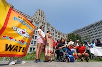 Judy DaSilva of Grassy Narrows (in wheelchair) leads a group in the Mother Earth Song during a rally to raise concerns and opposition to the Ontario provincial governmentÕs plans to expand mining operations in the so-called Ring of Fire region in Northern Ontario, in Toronto, Thursday, July 20, 2023. THE CANADIAN PRESS/Cole Burston