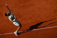 PARIS, FRANCE - JUNE 04: Carlos Alcaraz of Spain serves against Lorenzo Musetti of Italy during the Men's Singles Fourth Round match on Day Eight of the 2023 French Open at Roland Garros on June 04, 2023 in Paris, France. (Photo by Clive Mason/Getty Images)