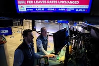 FILE PHOTO: Traders react as a screen displays the Fed rate announcement on the floor of the New York Stock Exchange (NYSE) in New York City, U.S., January 31, 2024.  REUTERS/Brendan McDermid/File Photo