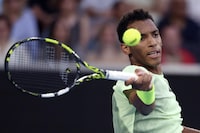Felix Auger-Aliassime of Canada plays a forehand return to Daniil Medvedev of Russia during their third round match at the Australian Open tennis championships at Melbourne Park, Melbourne, Australia, Saturday, Jan. 20, 2024. (AP Photo/Asanka Brendon Ratnayake)