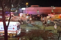 Image taken from a video showing ambulances and rescue teams staffers outside an immigration center in Ciudad Juarez, Mexico, Tuesday, March 28, 2023. At least three dozen migrants have died in a fire at an immigration detention center in northern Mexico near the U.S. border, according to a newspaper report. Images from the scene showed rows of bodies lying under shimmery silver sheets outside the facility in Ciudad Juarez, across from El Paso, Texas. Ambulances, firefighters and vans from the morgue could also be seen. (AP Photo)
