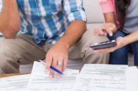 Cropped image of couple calculating finances at home