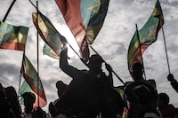 Protesters wave Ethiopian flags during a rally against pro-TPLF forces (Tigray People's Liberation Front) and to support for Ethiopia's armed forces in Addis Ababa on August 08, 2021. (Photo by Amanuel Sileshi / AFP) (Photo by AMANUEL SILESHI/AFP via Getty Images)