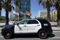 FILE - A Los Angeles Police Department vehicle is parked outside the LAPD headquarters downtown Los Angeles Friday, July 8, 2022. The Los Angeles police chief and the department's constitutional policing director are under investigation after the names and photographs of undercover officers were released to a technology watchdog group that posted them online, the Los Angeles Times reported.  (AP Photo/Damian Dovarganes, File)