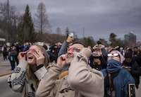 If you're wondering whether there is a Guinness World Record for "largest gathering of people dressed as the sun", the answer is, yes, and it now belongs to Niagara Falls, Ont. People watch the total solar eclipse in Niagara Falls, Ont., on Monday, April 8, 2024. THE CANADIAN PRESS/Aaron Lynett