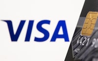 Credit card is seen in front of displayed Visa logo in this illustration taken, July 15, 2021. REUTERS/Dado Ruvic/Illustration