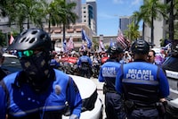 Members of law enforcement stand guard as supporters of former President Donald Trump rally outside the Wilkie D. Ferguson Jr. U.S. Courthouse, Tuesday, June 13, 2023, in Miami, after Trump arrived at the federal court. Trump is making a federal court appearance on dozens of felony charges accusing him of illegally hoarding classified documents and thwarting the Justice Department's efforts to get the records back. (AP Photo/Alex Brandon)