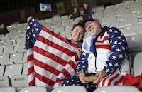 David Tritz, from Laguna Hills, California, and his daughter Erin Tritz, pose for a photo after taking their seats at the Women's World Cup soccer match between New Zealand and Norway in Auckland, New Zealand, Thursday, July 20, 2023. An estimated 20,000 Americans are coming to New Zealand for the Women's World Cup, and many have arrived in the days before the U.S. women's team plays its opener against Vietnam on Saturday (AP Photo/Rafaela Pontes)