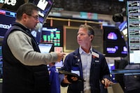 FILE PHOTO: Traders work on the trading floor at the New York Stock Exchange (NYSE) in New York City, U.S., November 22, 2023.  REUTERS/Brendan McDermid/File Photo