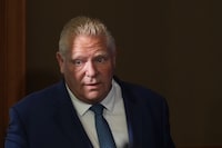Ontario Premier Doug Ford enters a room to speak to journalists at the Queens Park Legislature in Toronto on Tuesday, Sept. 5, 2023. Ontario will review the Greenbelt land swaps that two provincial watchdogs have said were rushed and flawed, Ford said Tuesday. THE CANADIAN PRESS/Chris Young