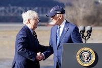 U.S. President Joe Biden shakes hands with U.S. Senate Republican Leader Mitch McConnell (R-KY) during an event to tout the new Brent Spence Bridge over the Ohio River between Covington, Kentucky and Cincinnati, Ohio near the bridge in Covington, Kentucky, U.S., January 4.