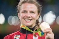 Canada's Erica Wiebe displays her gold medal after defeating Kazakhstan's Guzel Manyurova to win their women's 75kg freestyle wrestling gold medal match at the 2016 Summer Olympics in Rio de Janeiro, Brazil on Thursday, August 18, 2016. Wiebe announced her retirement from competition on Wednesday.THE CANADIAN PRESS/Ryan Remiorz