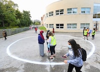 Teachers register students in physical distancing circles at Portage Trail Community School which is part of the Toronto District School Board (TDSB) during the COVID-19 pandemic in Toronto on Tuesday, September 15, 2020. THE CANADIAN PRESS/Nathan Denette