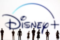 FILE PHOTO: Toy figures of people are seen in front of the displayed Disney + logo, in this illustration taken January 20, 2022. REUTERS/Dado Ruvic/Illustration/File Photo