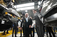 Ontario Premier Doug Ford and Prime Minister Justin Trudeau look over a vehicle along an assembly line at an event announcing plans for a Honda electric vehicle battery plant in Alliston, Ont. on Thursday, April 25, 2024. THE CANADIAN PRESS/Nathan Denette