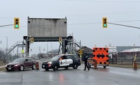 Niagara Regional Police block off a bridge near Lock 1 off the Welland Canal following an early morning explosion and fire in the surrounding area, in St. Catherines, Ontario, Thursday January 12, 2023. Police in St. Catharines, Ont., are evacuating some homes and businesses while warning other residents to stay indoors after reports of explosions and fire near an industrial park in the city's north end. THE CANADIAN PRESS/Alex Lupus