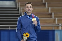 FILE - Gold medallist Ivan Litvinovich, of Belarus, poses for a photo during a medal ceremony after men's trampoline gymnastics at the 2020 Summer Olympics, on July 31, 2021, in Tokyo. The International Gymnastics Federation said Monday Jan. 15, 2024 it gave neutral status for competitions to 30 athletes and officials from Belarus though it is unclear how any could still qualify for the Paris Olympics. The only Belarusian gold medalist at the Tokyo Olympics, trampoline gymnast Ivan Litvinovich, is on the FIG list of approved people who could return to international competitions during the military invasion of Ukraine by Russia which Belarus supports. (AP Photo/Natacha Pisarenko, File)