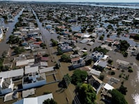 Aerial view of a flooded area of Canoas, a municipality north of Porto Alegre, Brazil, taken on May 7, 2024, after torrential rains devastated parts of the southern state of Rio Grande do Sul. Since the unprecedented deluge started last week, at least 90 people have died, 131 are missing and more than 150,000 were ejected from their homes by floods and mudslides in Rio Grande do Sul State, authorities said. (Photo by Nelson ALMEIDA / AFP) (Photo by NELSON ALMEIDA/AFP via Getty Images)