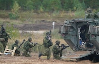 FILE - Canadian soldiers attend the NATO military exercises ''Namejs 2021'' at a training ground in Kadaga, Latvia, on Monday, Sept. 13, 2021. NATO responded to Russia's 2014 annexation of Ukraine's Crimean Peninsula by bolstering its forces near Russia and conducting drills on the territory of its Baltic members _ the maneuvers the Kremlin described as a security threat. (AP Photo/Roman Koksarov, File)