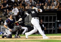 Chicago White Sox's Yoan Moncada (10) hits a one-run double against the Minnesota Twins during the seventh inning of a baseball game, Saturday, July 27, 2019, in Chicago. (AP Photo/David Banks)