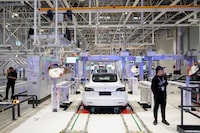 FILE PHOTO: Tesla China-made Model 3 vehicles are seen during a delivery event at its factory in Shanghai, China January 7, 2020. REUTERS/Aly Song