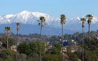 FILE - The snow-capped San Gabriel Mountains, with Mount Baldy the highest peak at the left, as seen from Chinatown near downtown Los Angeles, Jan. 12, 2016. Authorities say the latest search for missing actor Julian Sands on Southern California's massive Mount Baldy was unsuccessful. Sands was reported missing in January 2023 after setting out to hike on Mount Baldy, which rises more than 10,000 feet east of Los Angeles and was pounded by severe winter storms. (AP Photo/Nick Ut, File)