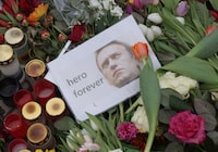 BERLIN, GERMANY - FEBRUARY 24: A photo of Russian opposition figure Aleksei Navalny that reads: "hero forever" lies among candles and flowers at a makeshift memorial to him in front of the Russian Embassy on February 24, 2024 in Berlin, Germany. Navalny died under ambiguous circumstances in a Siberian prison around February 16.  (Photo by Sean Gallup/Getty Images)
