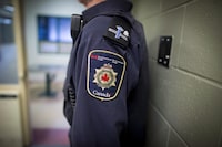 Patches are seen on the arm and shoulder of a corrections officer in Abbotsford, B.C., on Thursday Oct. 26, 2017. THE CANADIAN PRESS/Darryl Dyck