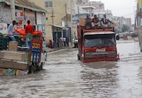 Vehicles try to maneuver through flood water caused by heavy rain, in Mogadishu, Saturday, Nov, 11, 2023. (AP Photo/Farah Abdi Warsameh)