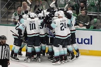 The Seattle Kraken celebrate after Yanni Gourde scored in overtime of Game 1 of an NHL hockey Stanley Cup second-round playoff series against the Dallas Stars, Tuesday, May 2, 2023, in Dallas. The Kraken won 5-4. (AP Photo/Tony Gutierrez)