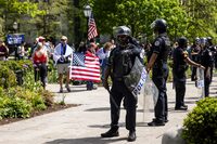 University of Chicago police keep watch as pro-Palestinians protesters and counter-protesters rally at the encampment in the quad at the University of Chicago on the South Side, Friday, May 3, 2024. (Ashlee Rezin/Chicago Sun-Times via AP)