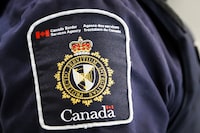 A Canada Border Services Agency (CBSA) patch is seen on an officer in Calgary on Thursday, Aug. 1, 2019. THE CANADIAN PRESS/Jeff McIntosh
