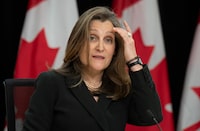 Deputy Prime Minister and Minister of Finance Chrystia Freeland adjusts her hair as she responds to a question during a news conference, in Ottawa, Wednesday, May 1, 2024. THE CANADIAN PRESS/Adrian Wyld