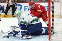 Vancouver Canucks goaltender Casey DeSmith (29) stops a Detroit Red Wings right wing Christian Fischer (36) shot in the first period of an NHL hockey game Saturday, Feb. 10, 2024, in Detroit. (AP Photo/Paul Sancya)