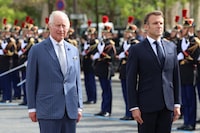 Britain's King Charles III (L) and French President Emmanuel Macron (R) stand to attention during an official welcoming ceremony at the Arc de Triomphe in Paris on September 20, 2023, on the first day of a state visit to France. Britain's King Charles III and his wife Queen Camilla are on a three-day state visit to France. (Photo by Chris Jackson / POOL / AFP) (Photo by CHRIS JACKSON/POOL/AFP via Getty Images)