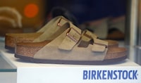 A pair of shoes is pictured in a window of a Birkenstock footwear store in Berlin, Germany, Jan. 21, 2021.