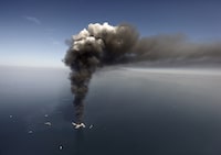 FILE - A large plume of smoke rises from fires on BP's Deepwater Horizon offshore oil rig in the Gulf of Mexico, more than 50 miles southeast of Venice on Louisiana's tip on April 2010. A new National Academy of Science study says that 13 years after a massive BP oil spill fouled the Gulf of Mexico, regulators and industry have reduced some risks in deep water exploration in the gulf but some troublesome safety issues persist. (AP Photo/Gerald Herbert, File)