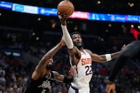 Phoenix Suns center Deandre Ayton, right, shoots as Los Angeles Clippers forward Marcus Morris Sr. defends during the second half in Game 4 of a first-round NBA basketball playoff series Saturday, April 22, 2023, in Los Angeles. (AP Photo/Mark J. Terrill)